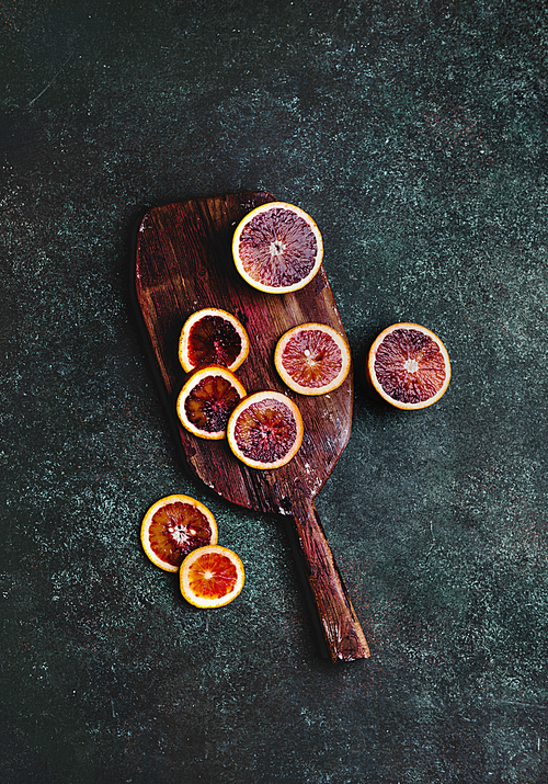 top view of cutting board with slices of blood orange on table