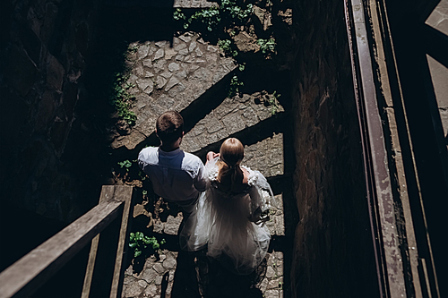 top view of bride and groom walking by old town