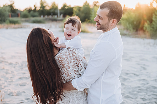 happy family with baby boy on beach together