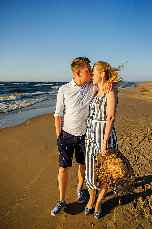 young tender couple in love on sandy beach in Riga, Latvia