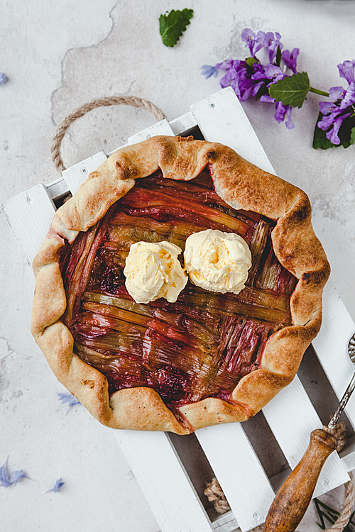 top view of yummy rhubarb pie with cream on table