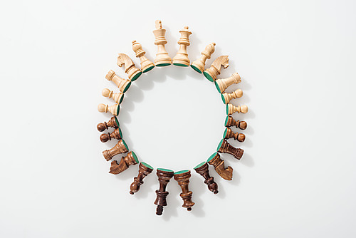 top view of round frame made of wooden chess figures on white background