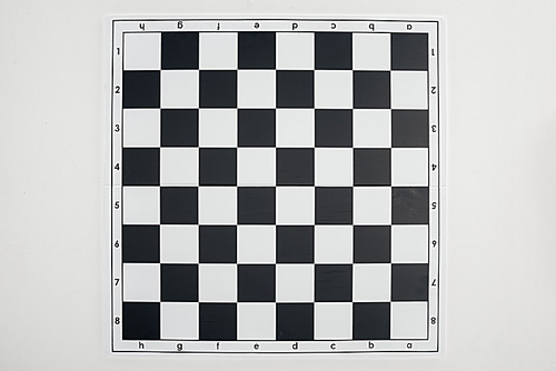 top view of empty  black and white chessboard on white background