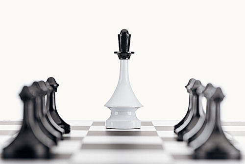 selective focus of chessboard with white queen figure among black pawns isolated on white