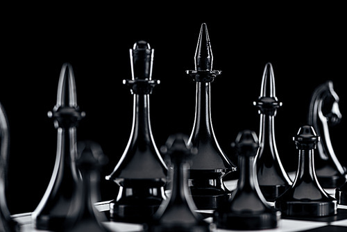 close up of chessboard with black chess figures isolated on black