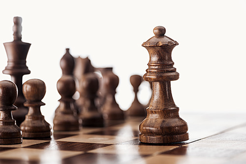 selective focus of wooden chessboard with chess figures isolated on white