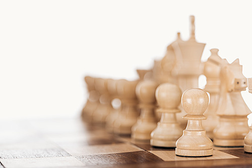 selective focus of beige and brown wooden chessboard with chess figures isolated on white