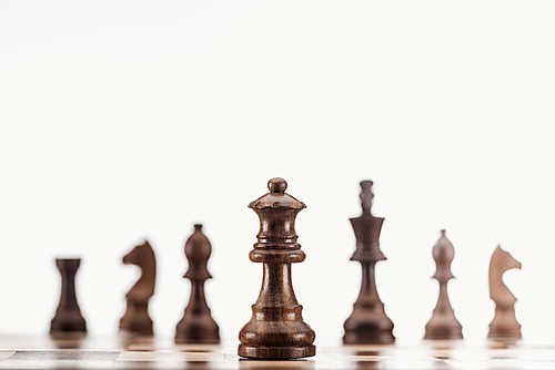 selective focus of brown wooden queen on chessboard isolated on white