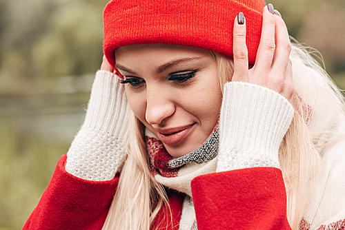 close-up portrait of beautiful young woman wearing red hat outdoors