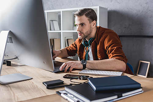 handsome young man working with computer at modern office