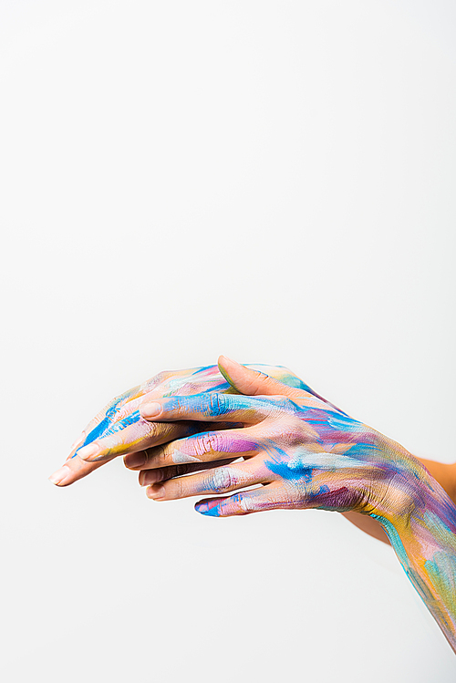 cropped image of girl with colorful bright body art touching hands isolated on white