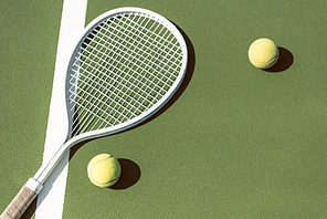 close up view of tennis equipment on green tennis court