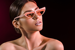 portrait of beautiful model in fashionable eyeglasses on dark background