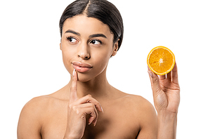 thoughtful african american girl holding half of orange and looking away isolated on white