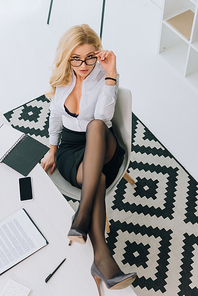 overhead view of sexy woman sitting in chair and 