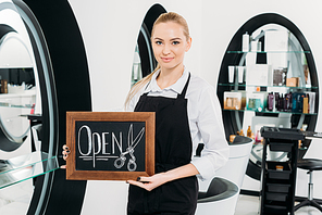 attractive hairdresser holding sign open