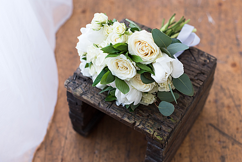 wedding bouquet with white roses on wooden stand