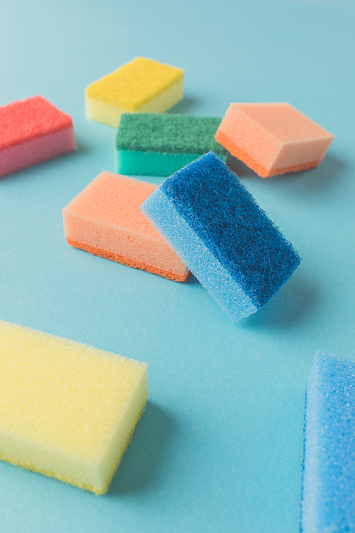 studio shot of colorful washing kitchen sponges, on blue