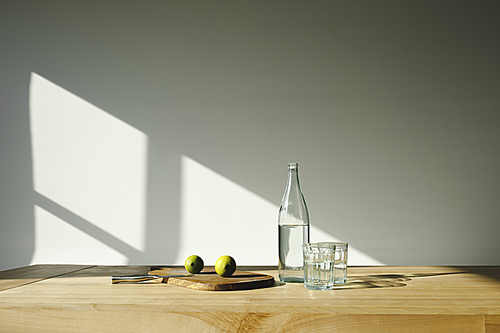 detox water with lime ingredients on brown wooden table