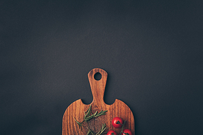 top view of cherry tomatoes and fennel on a wooden board