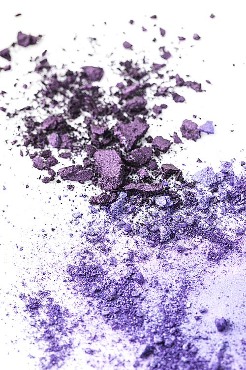 crushed purple cosmetic eye shadows on white tabletop