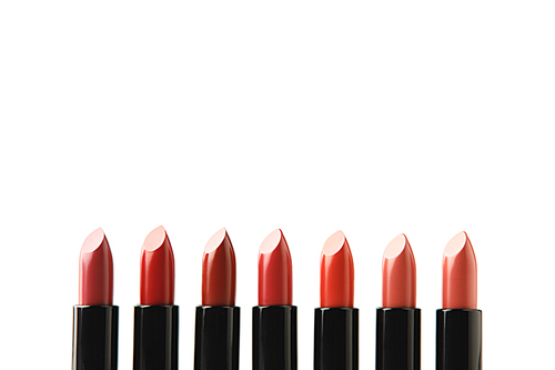 row of lipsticks of various shades isolated on white