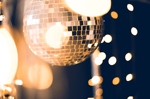 beautiful disco ball with golden garland on black