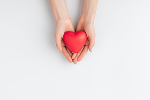 top view of hands holding red heart isolated on white background