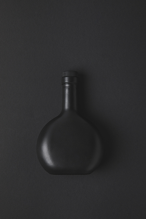top view of empty bottle on black surface