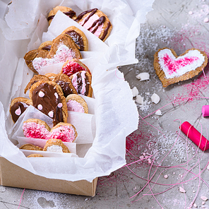close-up view of collection of sweet heart shaped cookies on grey surface