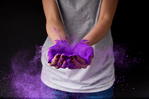cropped view of person with purple holi paint, isolated on black