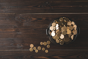 top view of pot of golden coins on wooden table, st patricks day concept