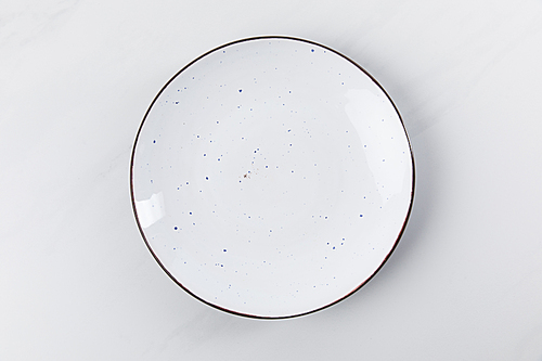 Top view image of plate placed on white surface, minimalistic conception