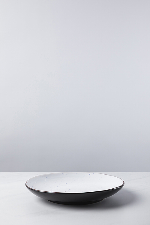 Plate placed on white surface, minimalistic conception