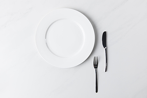 Top view of plate with fork and knife, table appointments conception