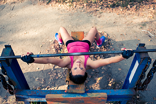Overhead view of female athlete training with weights at the outdoor gym