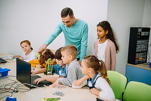 group of kids listening to teacher at machinery class