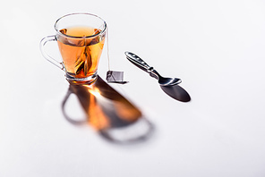 glass cup of 홍차 and spoon on table