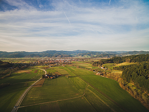 Aerial view of majestic landscape with green field and town in Germany