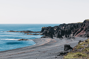 beautiful icelandic seacoast with cliffs and black sand