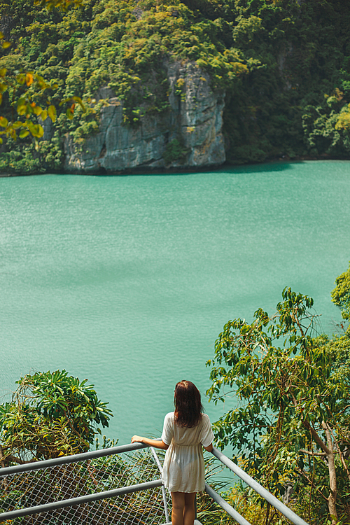 back view of woman looking at rocky island at Ang Thong National Park, Ko Samui, Thailand