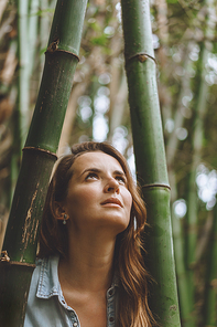 portrait of beautiful pensive woman standing among bamboo plants, Bali, Indonesia