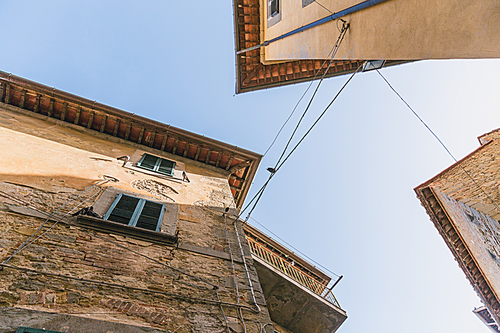 bottom view of buildings and clear blue sky in Tuscany, Italy