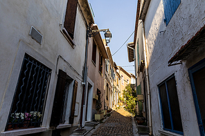 low angle view of cozy narrow street with traditional white houses in provence, france