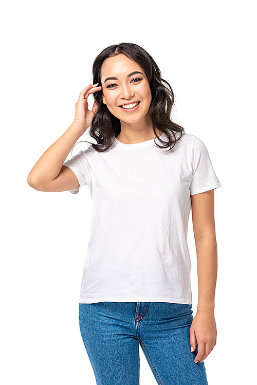 Pretty asian girl in t-shirt touching hair isolated on white