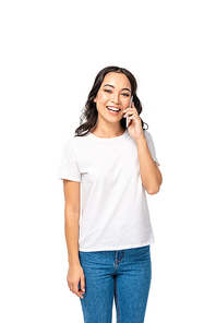 Smiling asian girl in white t-shirt and blue jeans talking on smartphone isolated on white