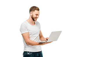 handsome smiling young man in white t-shirt using laptop isolated on white