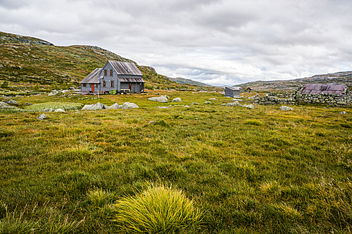 beautiful landscape with little house on meadow