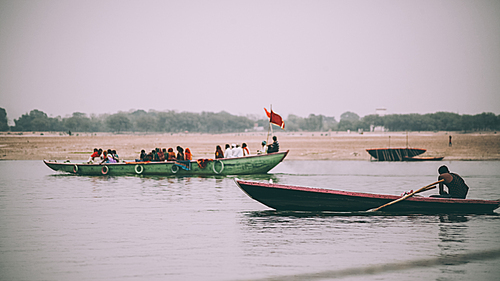 people on boats flowing on Ganges River in Varanasi, India
