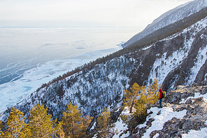 view of mountain slope with snow and trees and standing man,russia, lake baikal